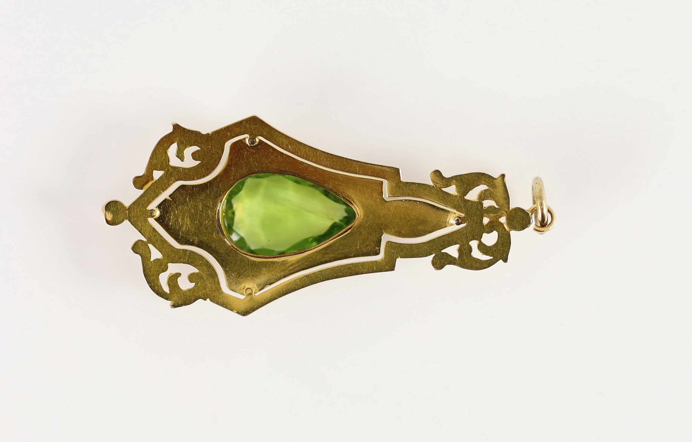 A late 19th/early 20th century gold, two colour enamel and peridot set pendant